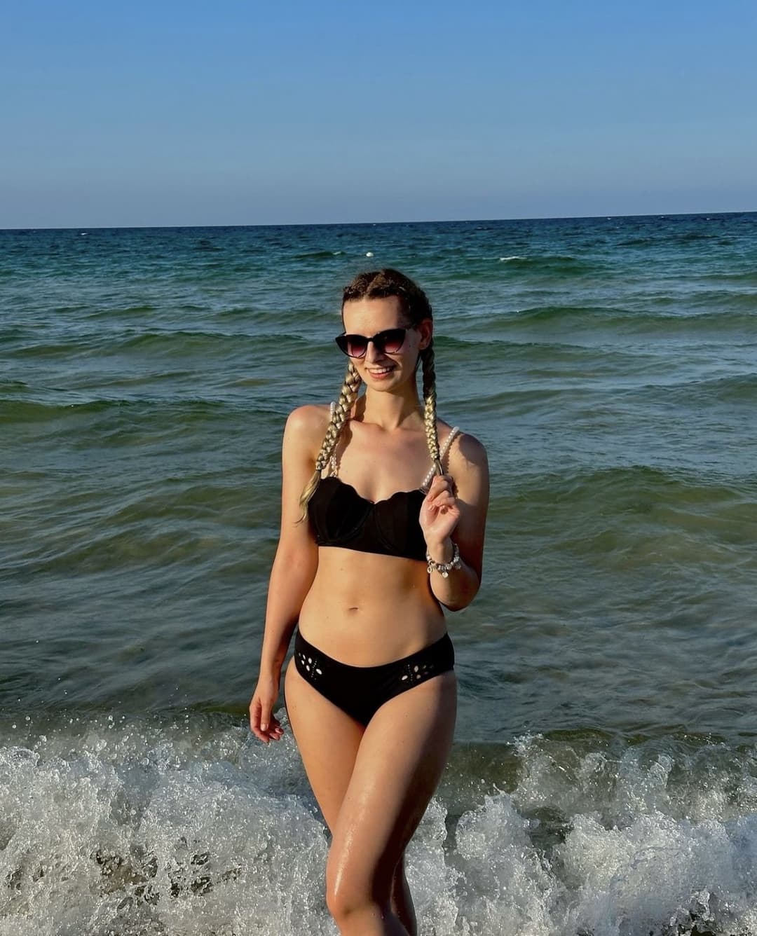 Cute little blonde Emilia Martis on the beach