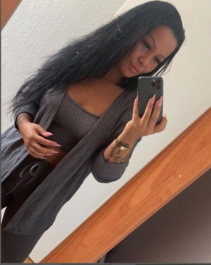 Brunette flashing belly and bra in public