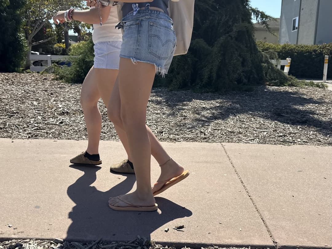 college young white native speaking sole smacking sandals at the beach