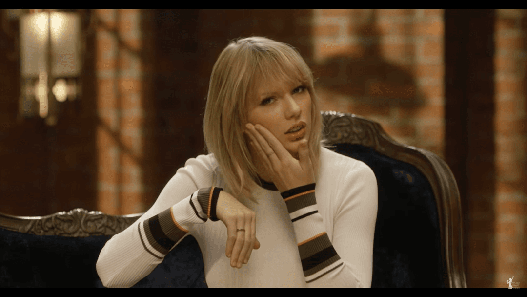 Taylor Swift tight white sweater, leather skirt, leather heels