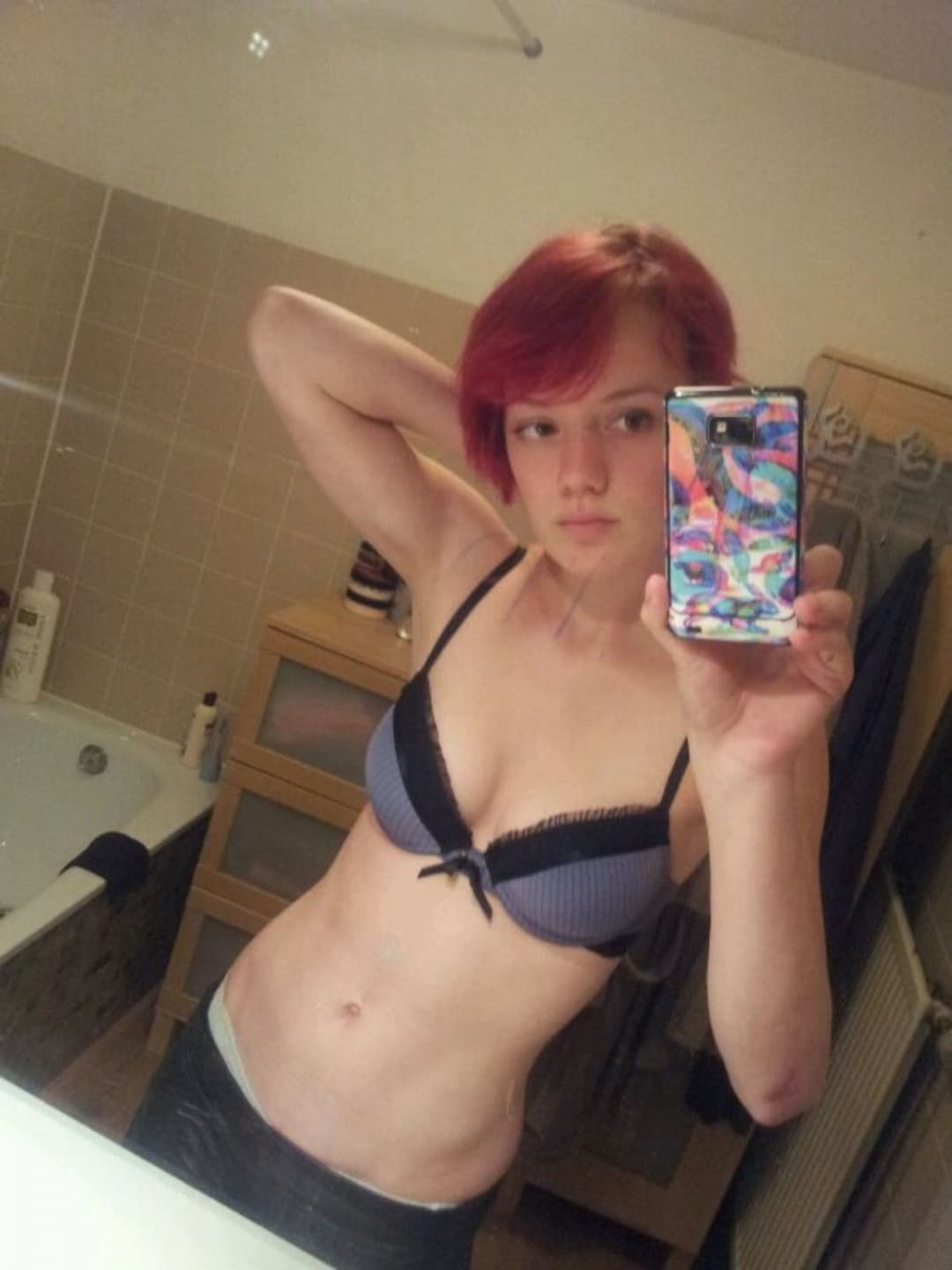 Emo redhead with perky tits teases for the camera