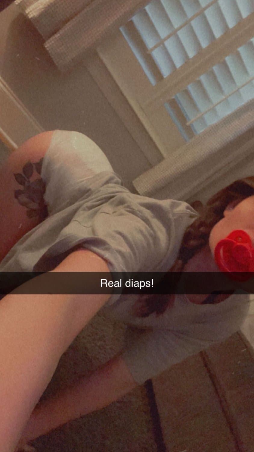 Cute tanned girl shows off her diapers and pull-ups