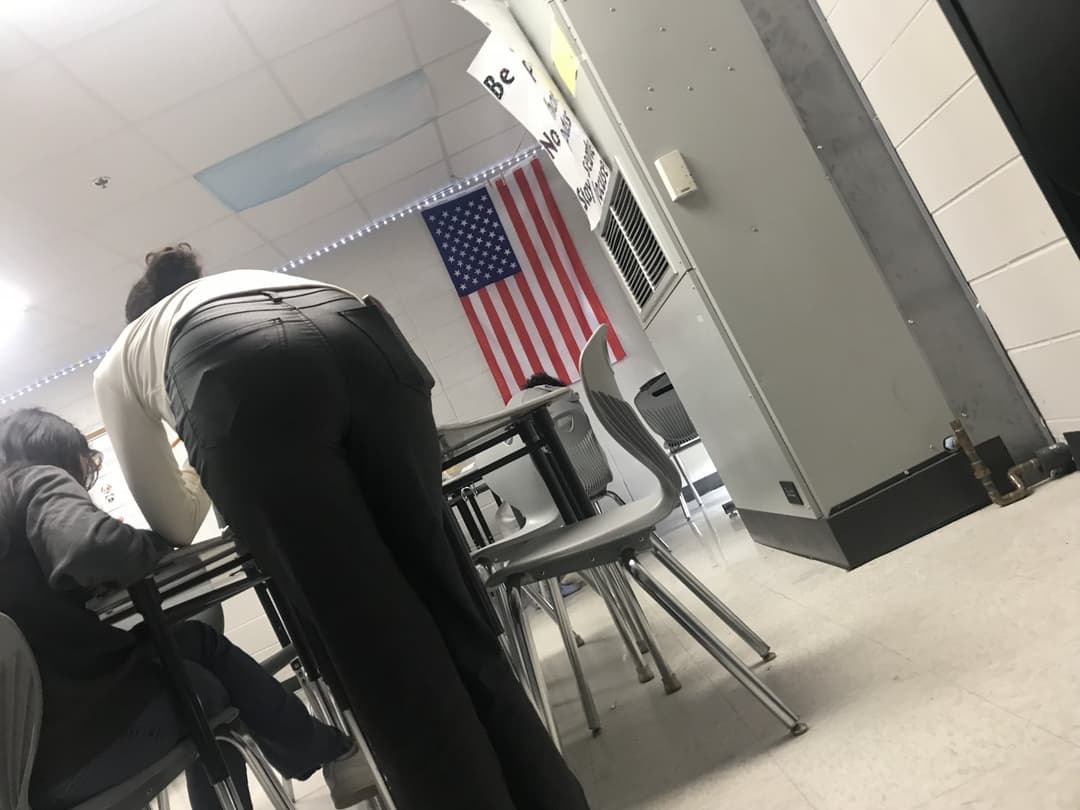 Candid teacher helping students