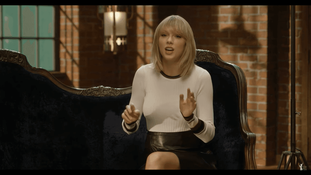 Taylor Swift tight white sweater, leather skirt, leather heels