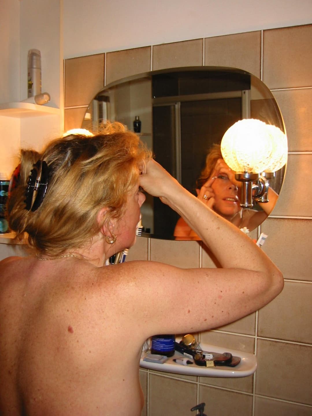 Old slut gets ready for friends in the bathroom