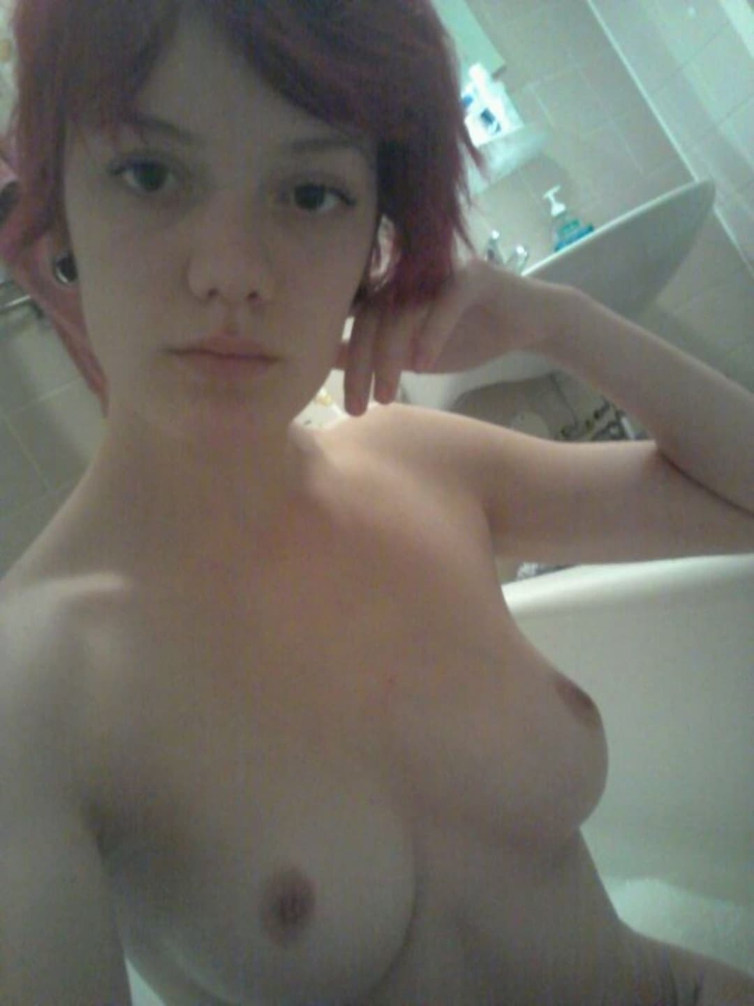 Emo redhead with perky tits teases for the camera