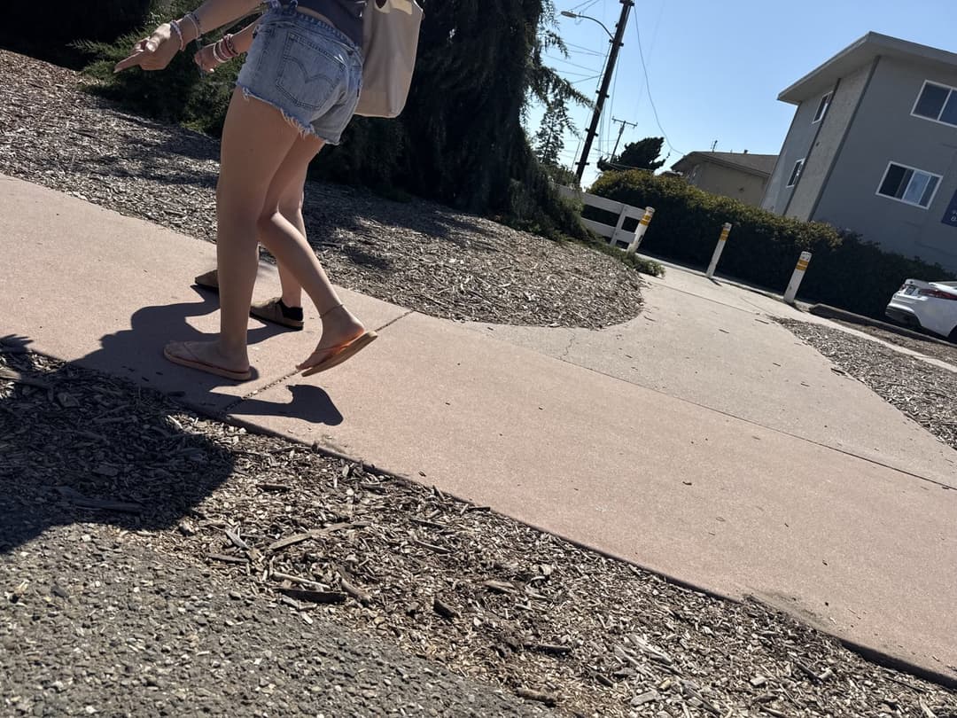 college young white native speaking sole smacking sandals at the beach