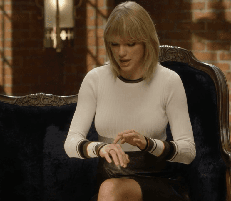 Taylor Swift tight white sweater, leather skirt, leather heels