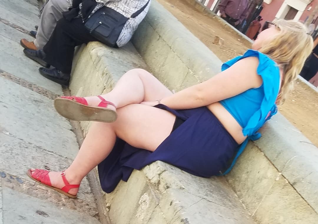 blonde sitting, legs open, nice thick legs