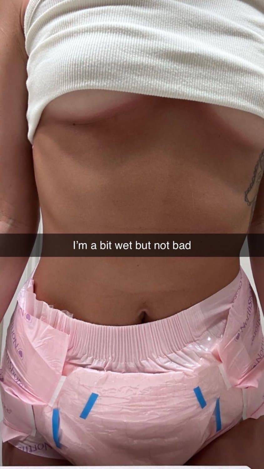 Cute tanned girl shows off her diapers and pull-ups