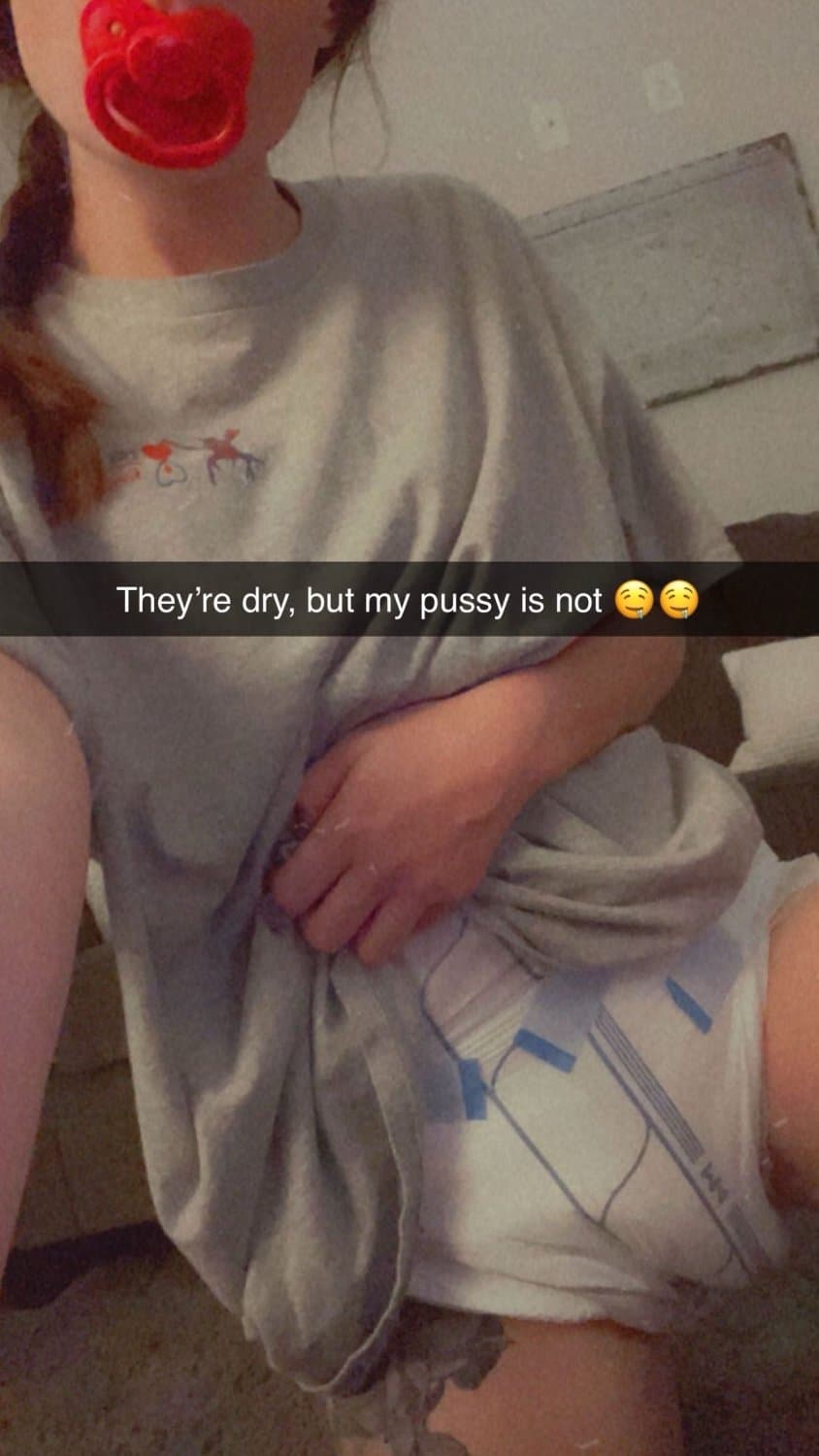 Cute tanned girl shows off her diapers and pull-ups