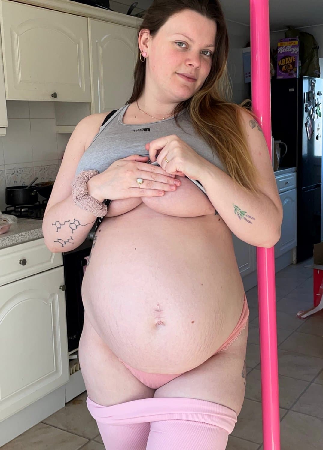 Pregnant sol model oils up her huge boobs and belly bump