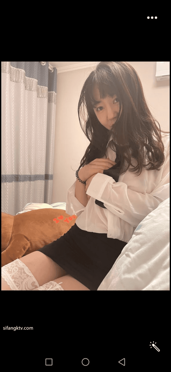 Serious looking AZN college girl behind the scene