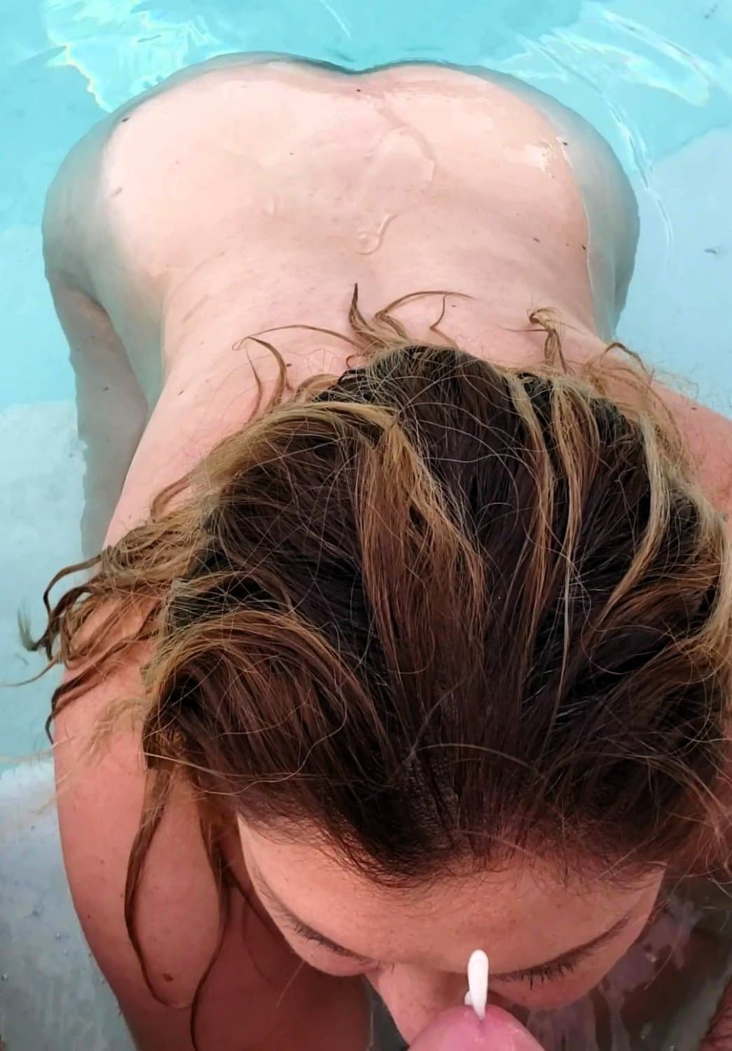 big boobed wife takes a facial in the pool