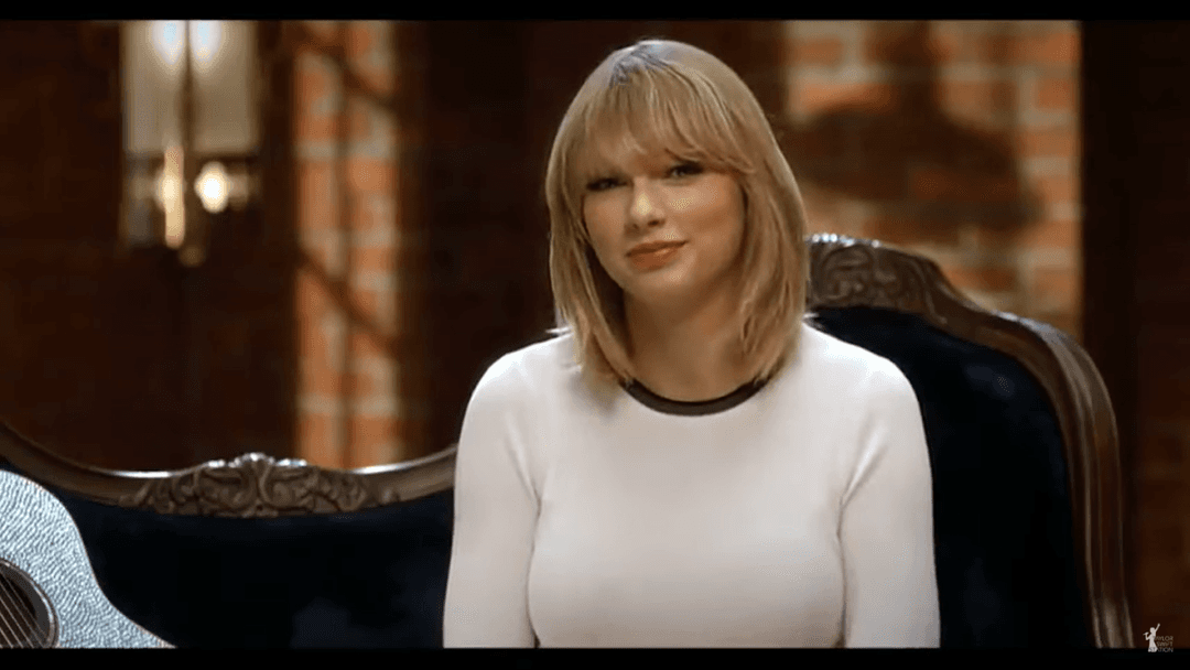 Taylor Swift tight white sweater, leather skirt, leather heels