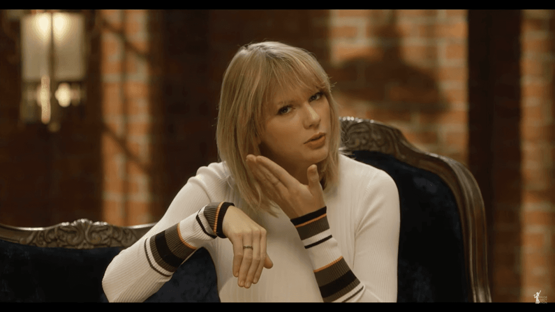 Taylor Swift tight white sweater, leather skirt, leather heels