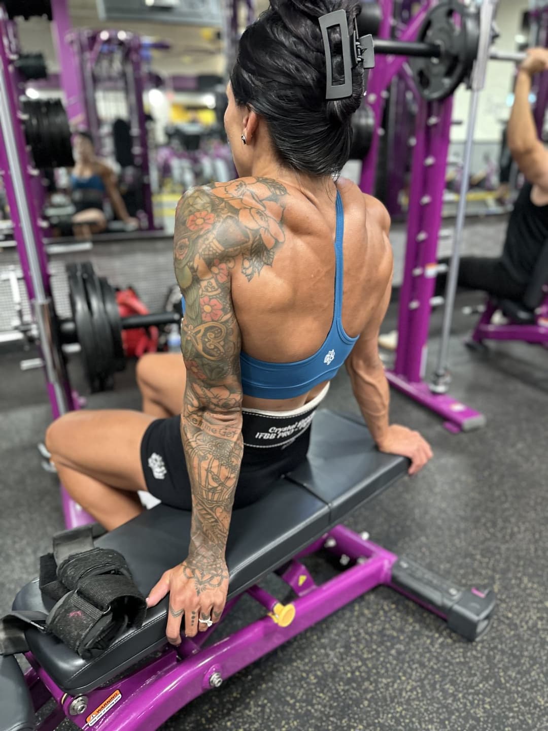 An athletic gym girl has a nice, muscular back