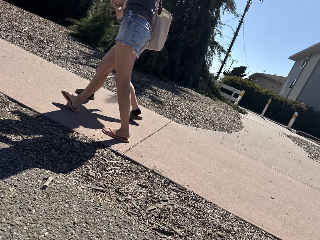 college young white native speaking sole smacking sandals at the beach
