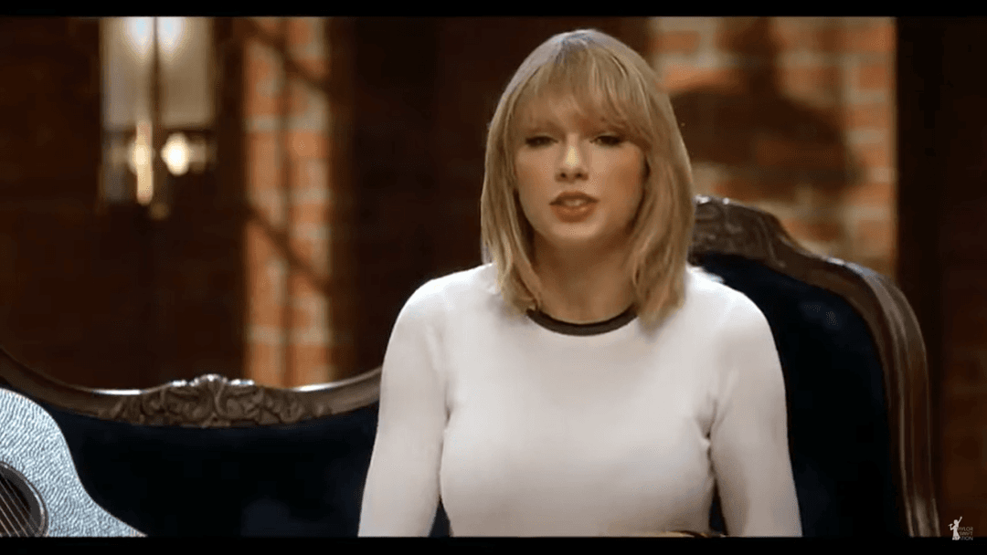 Taylor Swift tight white sweater, leather skirt, leather heels