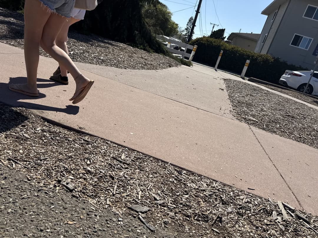 college young white native speaking sole smacking sandals at the beach