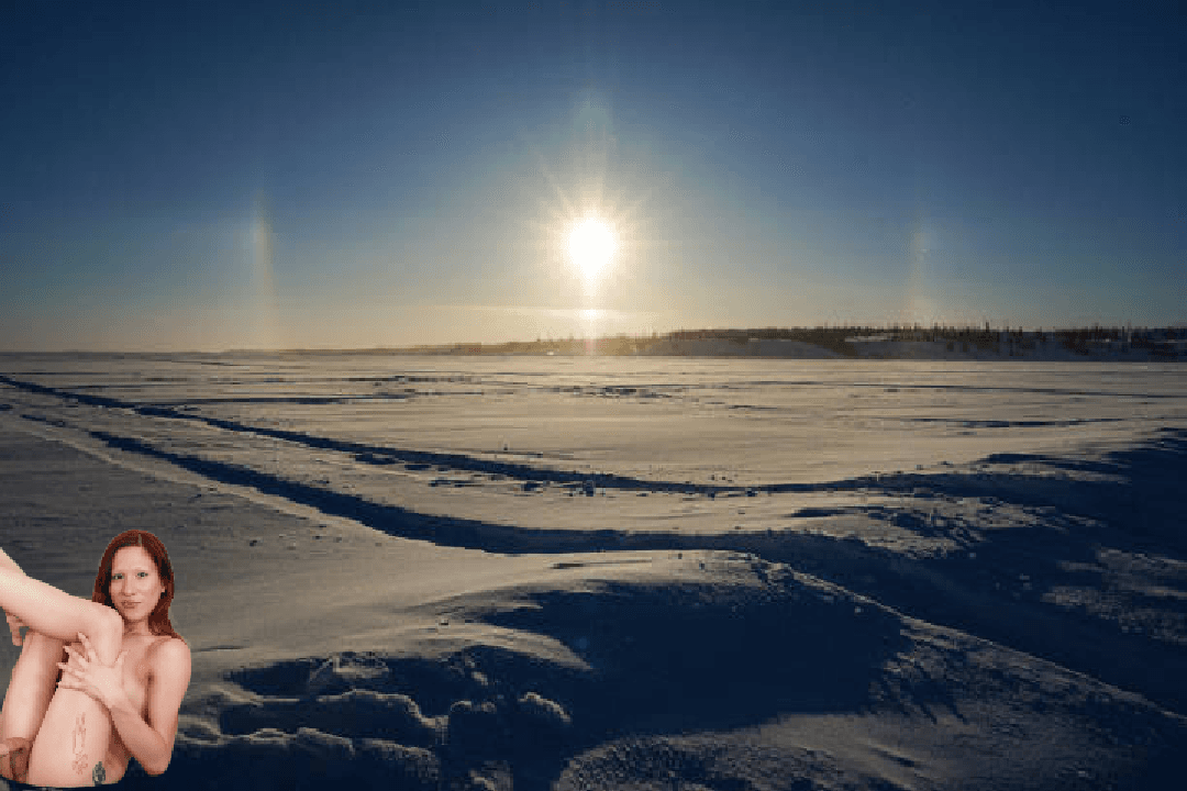 Red Haired Transwoman Drewcilla Under A Sun Halo Over Yellowknife Bay On Great Slave Lake