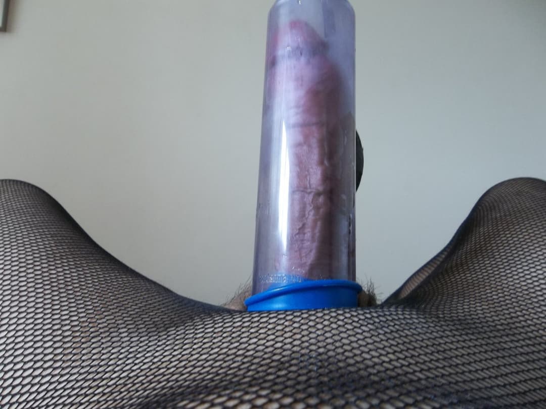 cross dresser playing with a cock pump