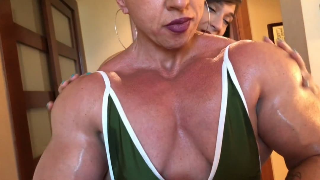 Click to view full size Mrs Bayres, hands on the enormous muscles of Mrs Sanchez