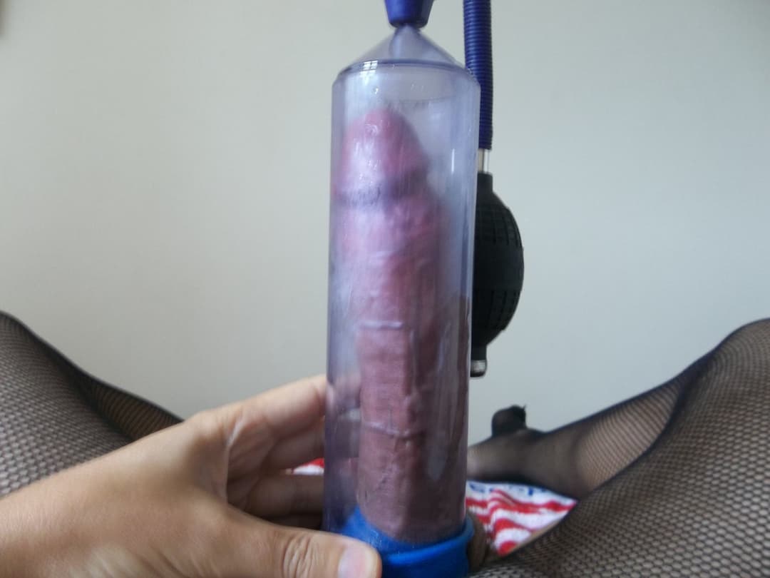 cross dresser playing with a cock pump