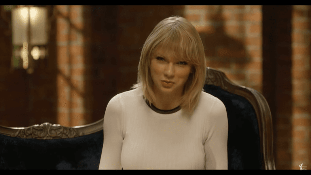 Taylor Swift tight white sweater, leather skirt, leather heels