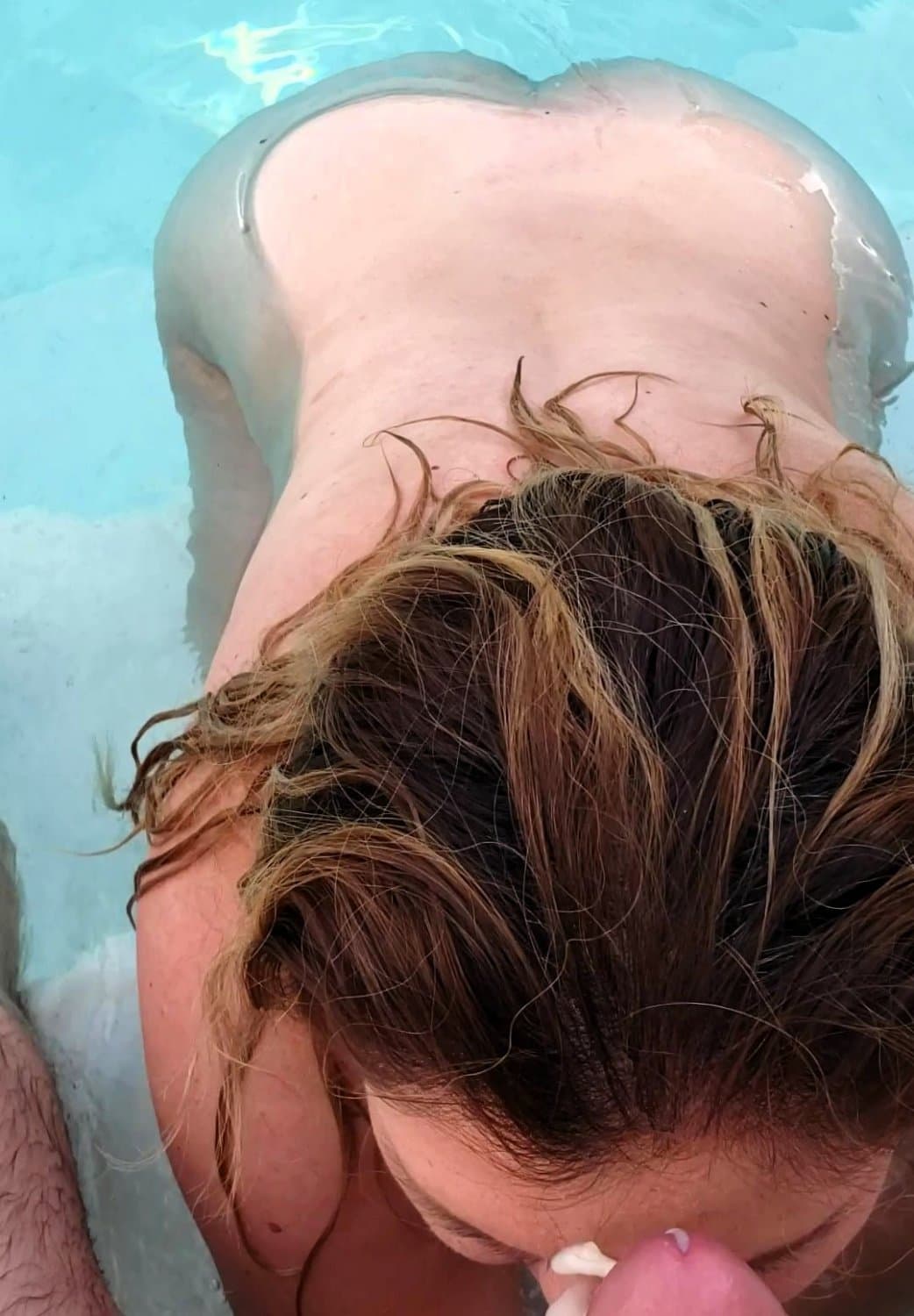 big boobed wife takes a facial in the pool