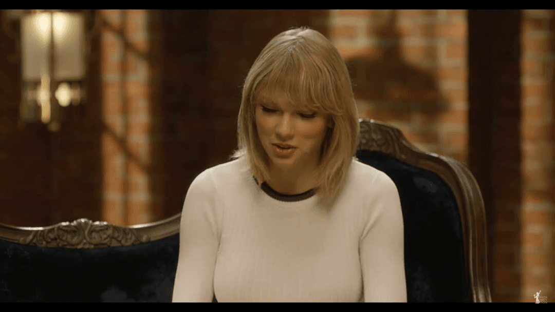 Taylor Swift tight white sweater, leather skirt, leather heels