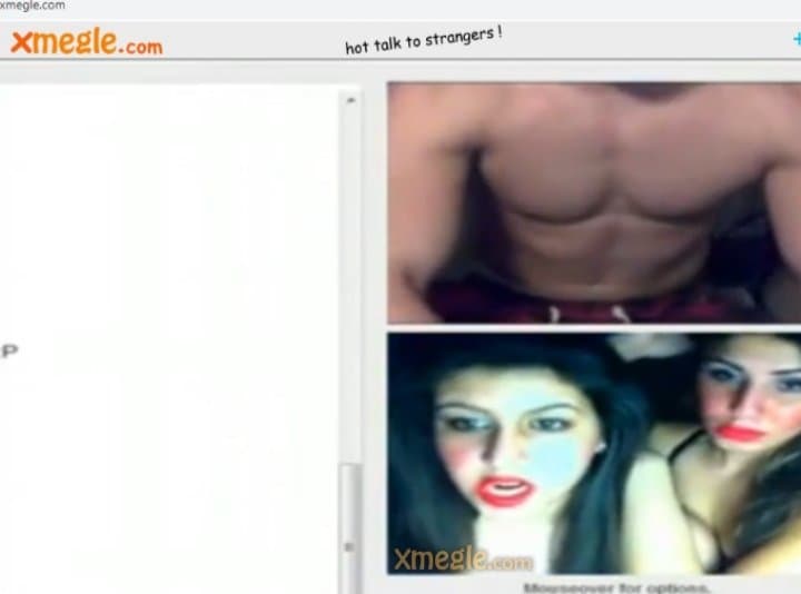 Three dark-haired girls communicate with a handsome guy in a video chat