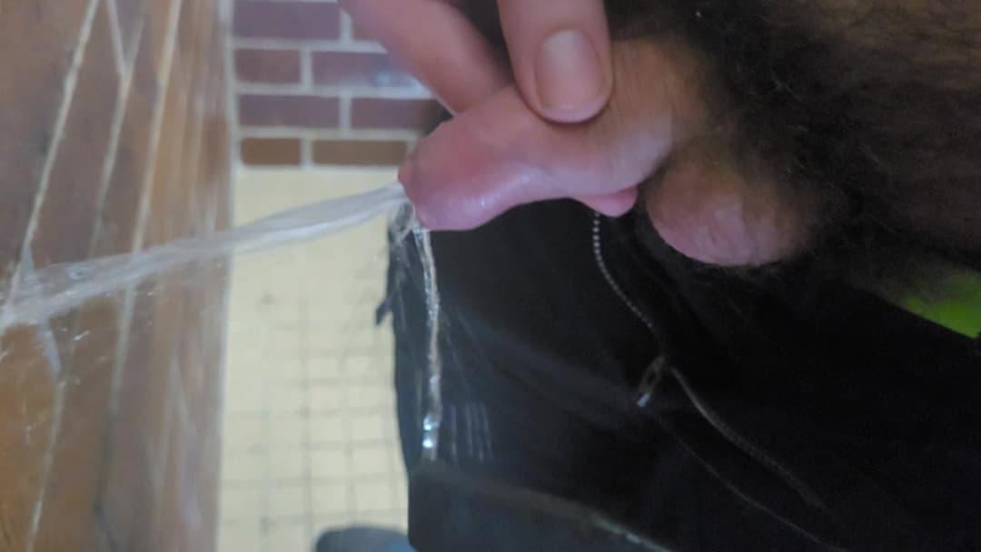 Messy public bathroom wall pee