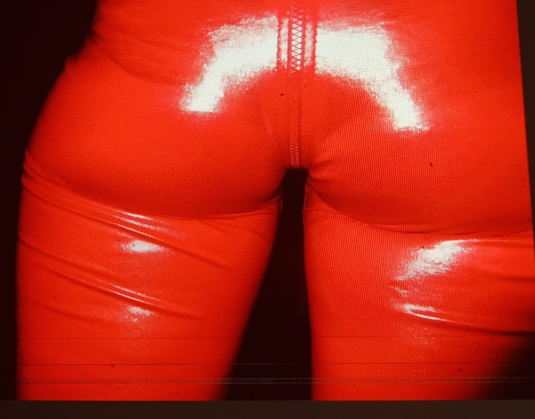 English petite biker milf in red pvc catsuit strips naked again tattoos and pierced nipples