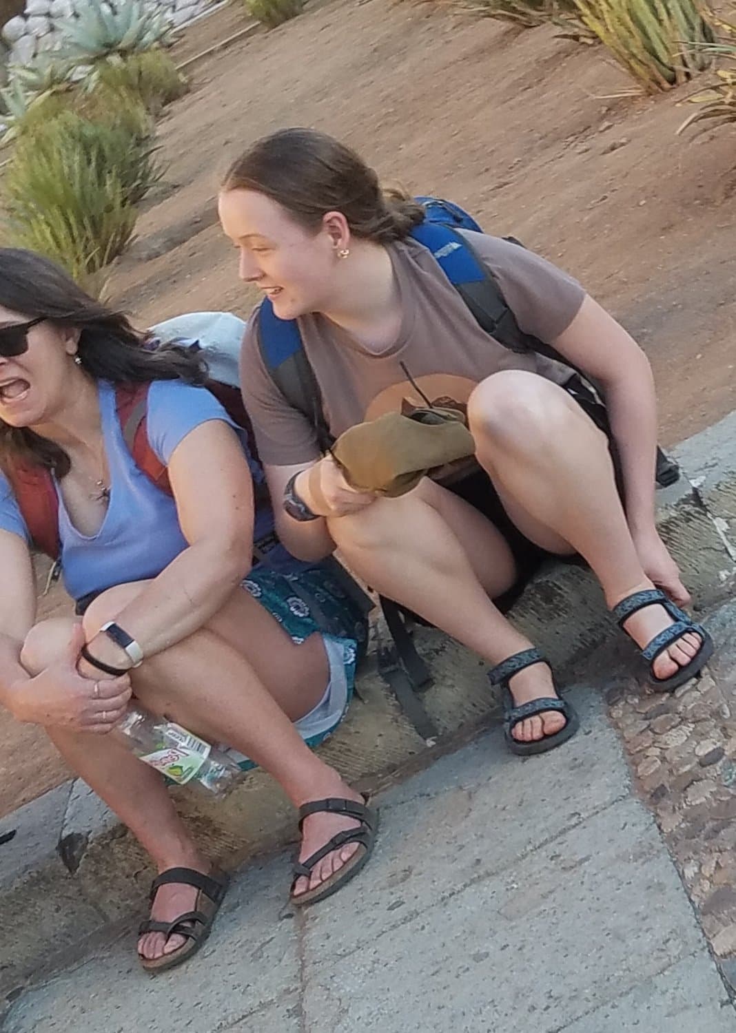 some girls sitting, showing legs and little else