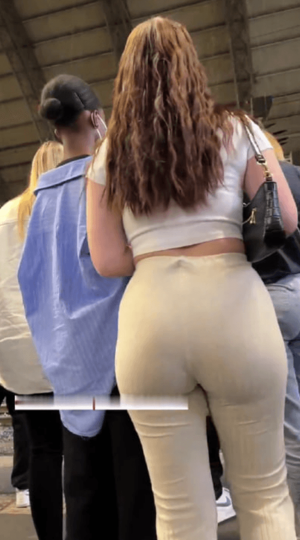 girl in hot flare pants walking down the street