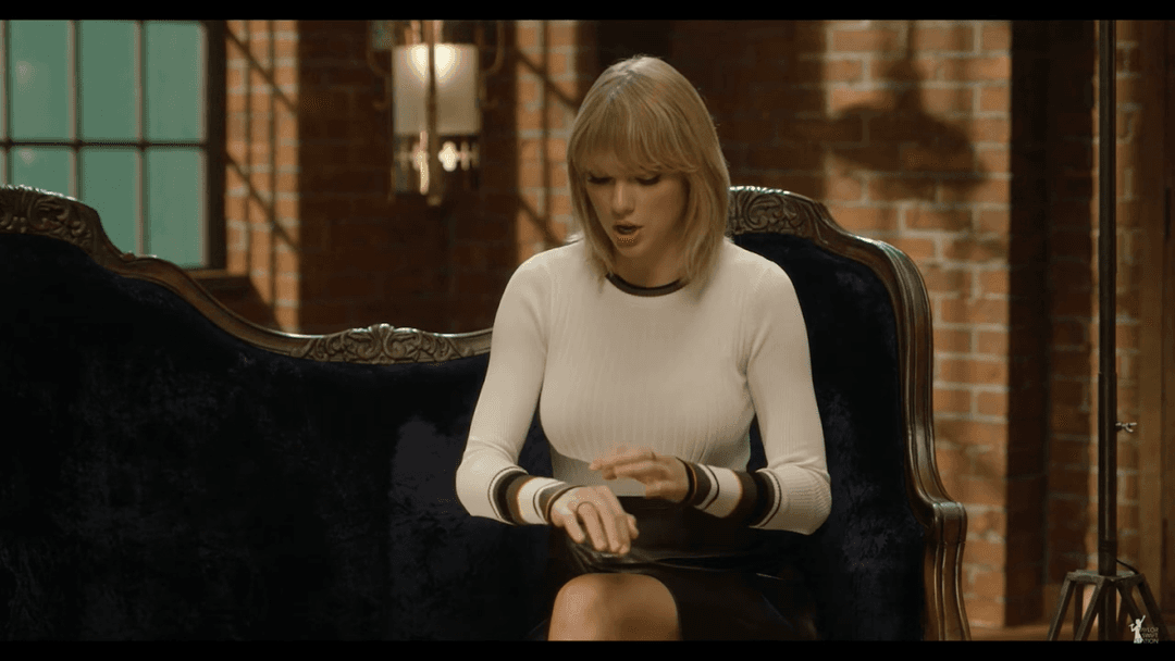 Taylor Swift tight white sweater, leather skirt, leather heels