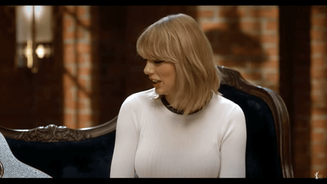 Taylor Swift tight white sweater, leather skirt, leather heels