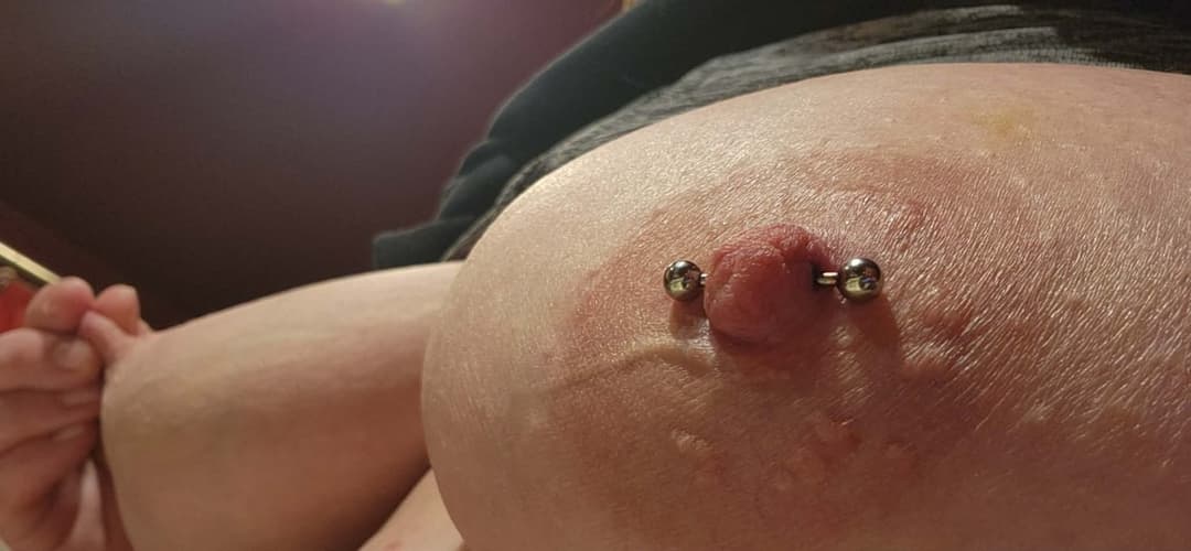 Girlfriend showing off new nipple piercing.