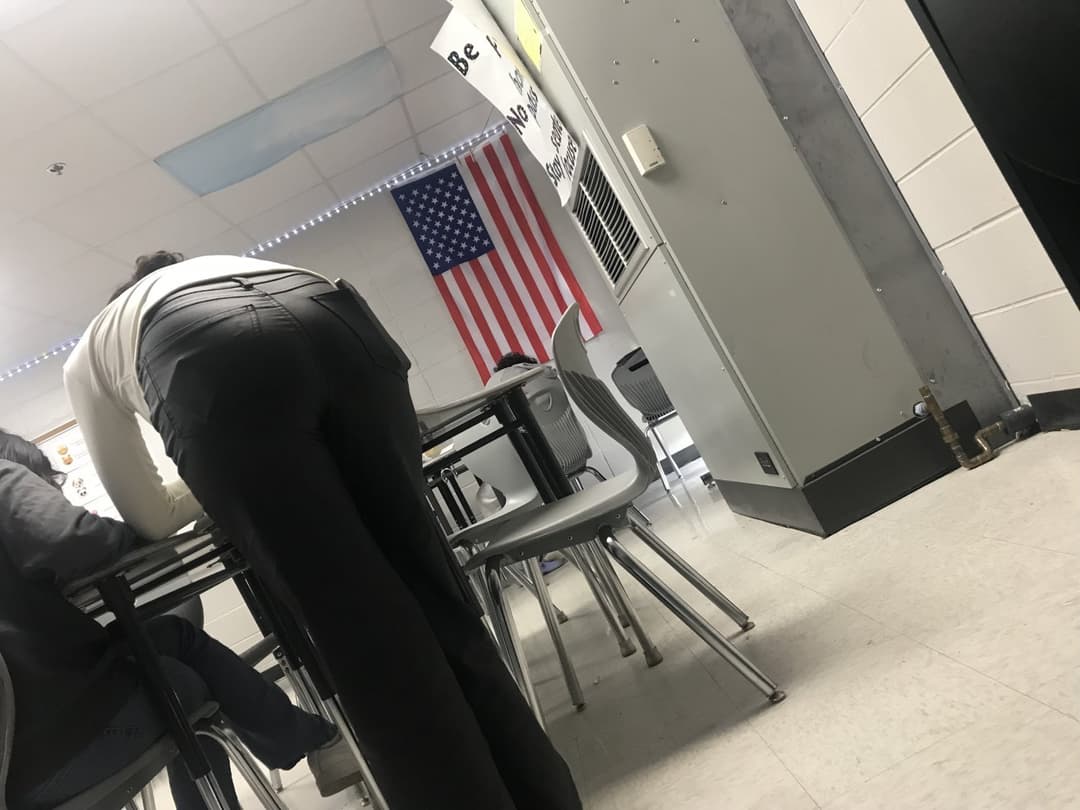 Candid teacher helping students
