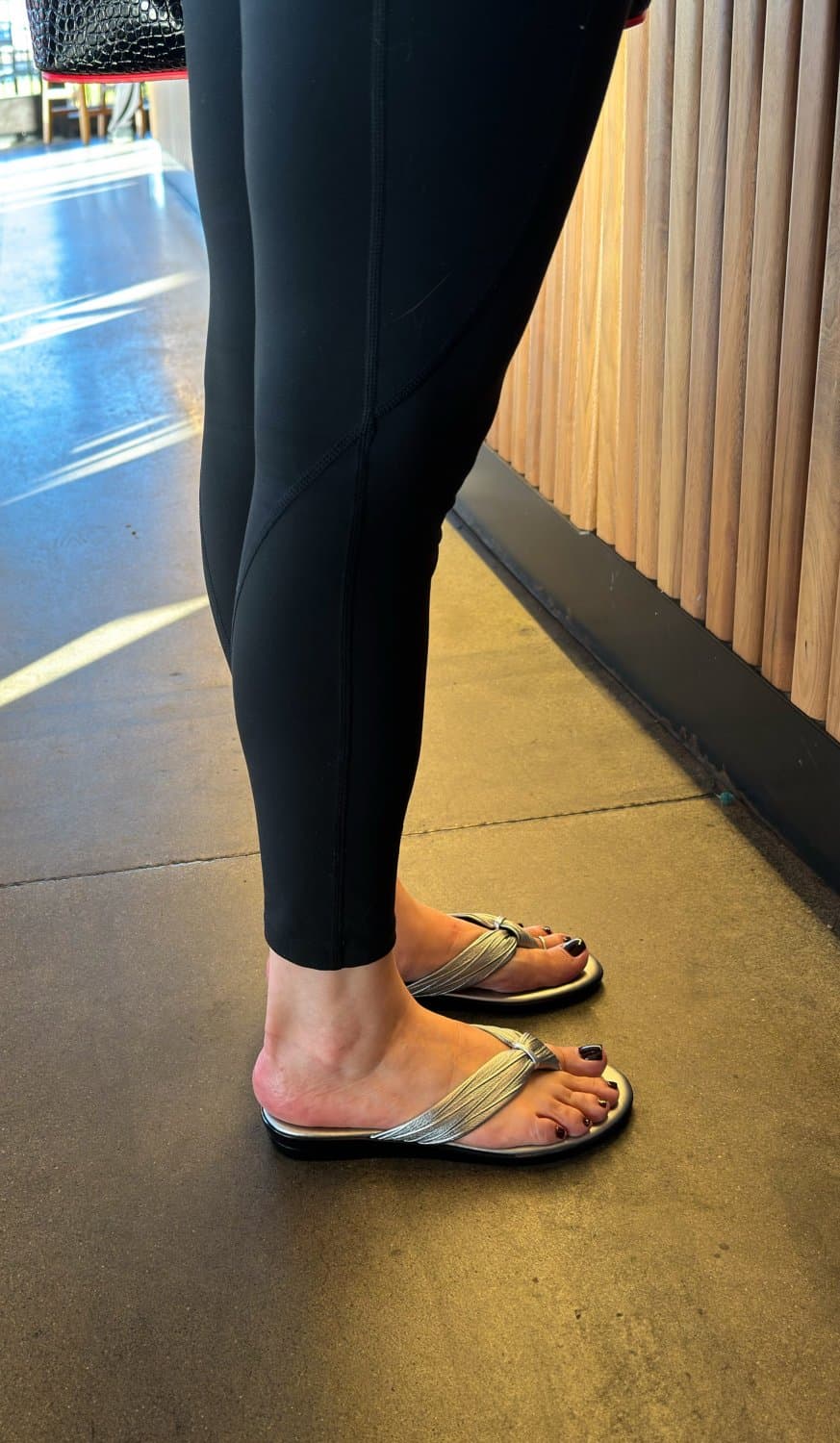 Moms friend in metallic flip flops