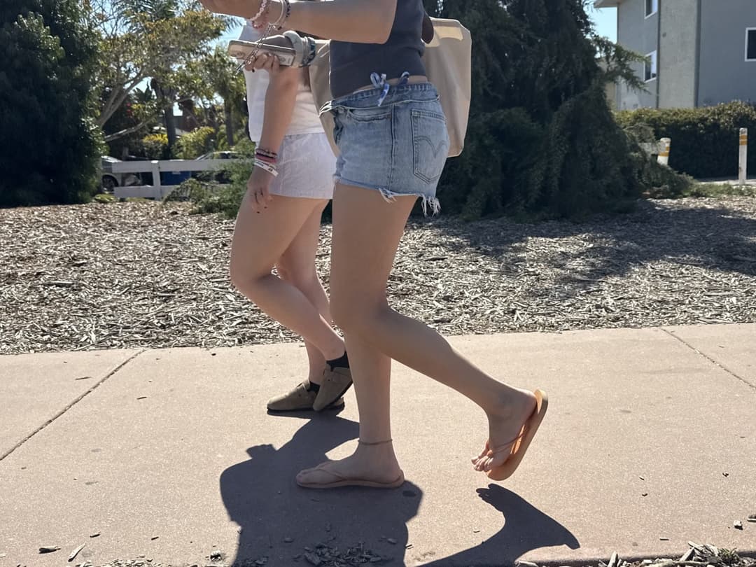 college young white native speaking sole smacking sandals at the beach