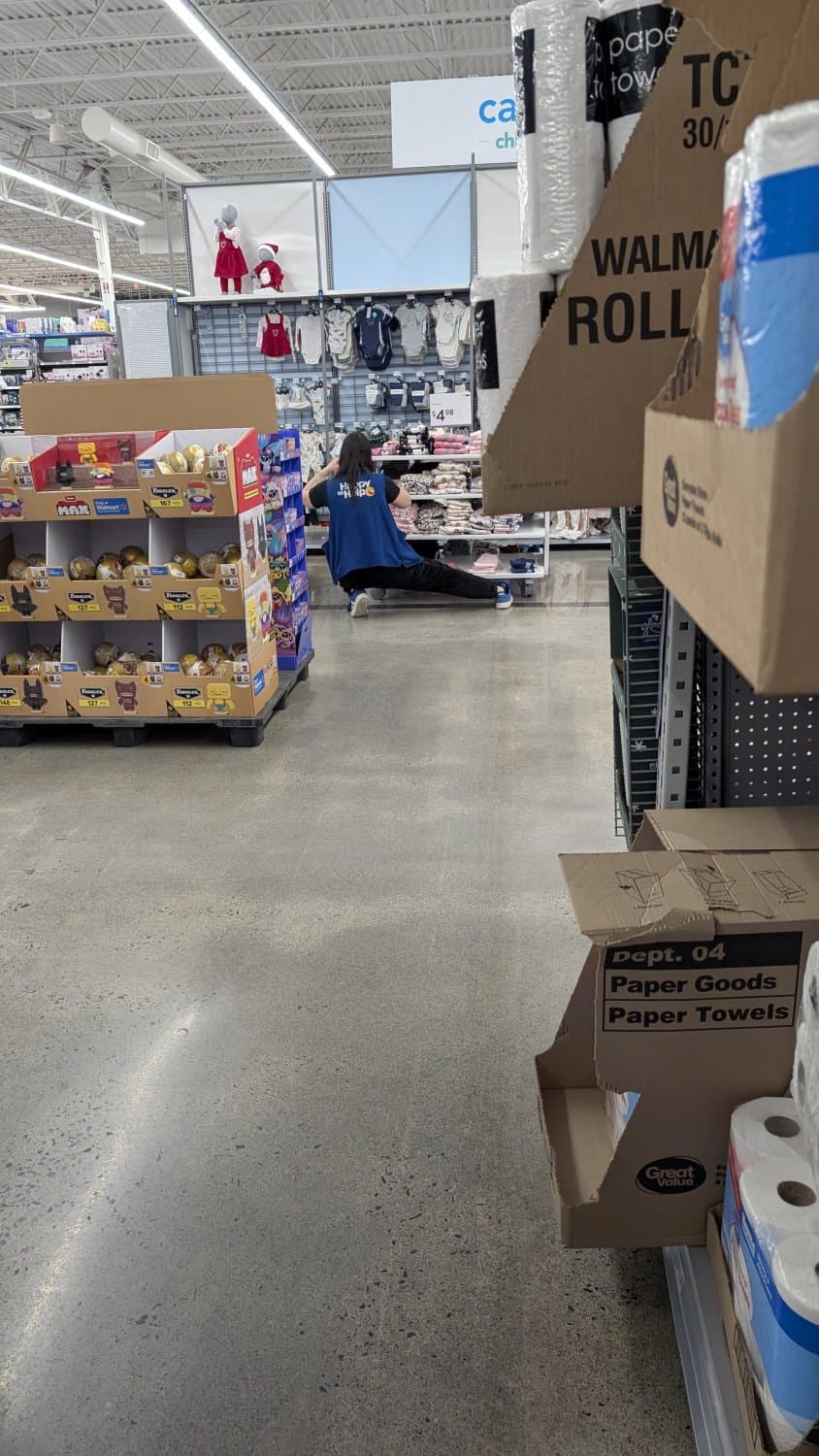 Creepshots of Lindsay doing a split while arranging clothes in apparel. Zoom in for panty shot.