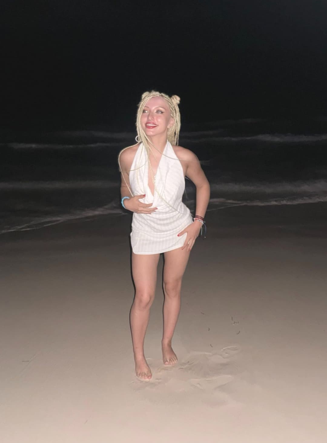 Soft waves,  dark skies, she glows in the dark