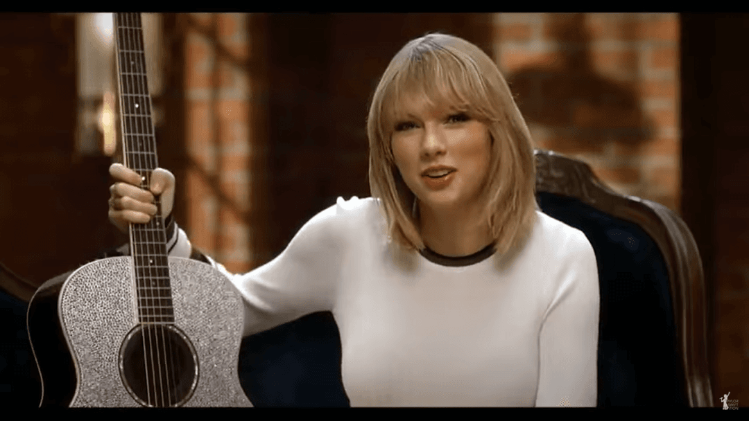 Taylor Swift tight white sweater, leather skirt, leather heels