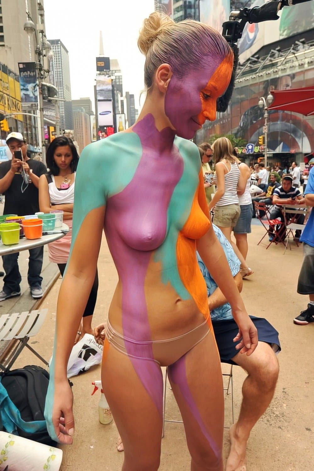 Nudist girls doing body paint in public