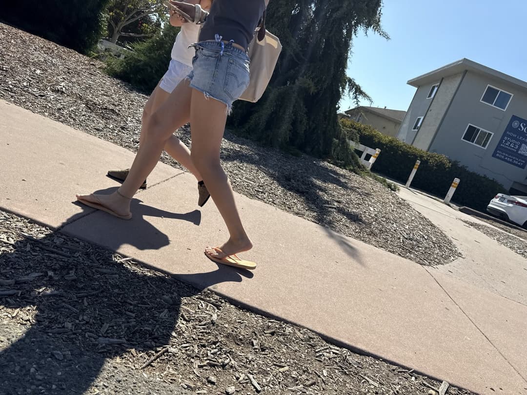 college young white native speaking sole smacking sandals at the beach