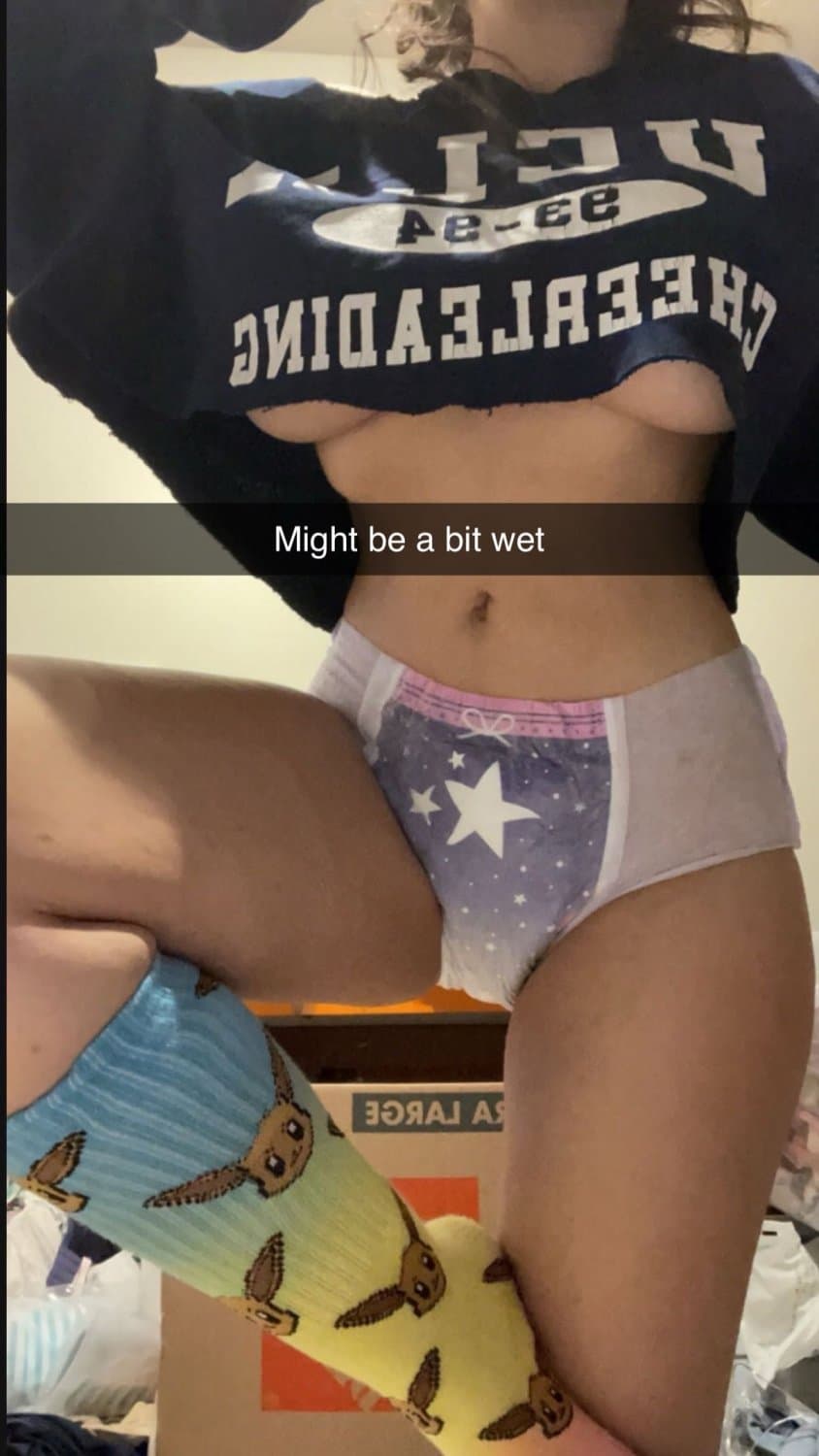 Cute tanned girl shows off her diapers and pull-ups