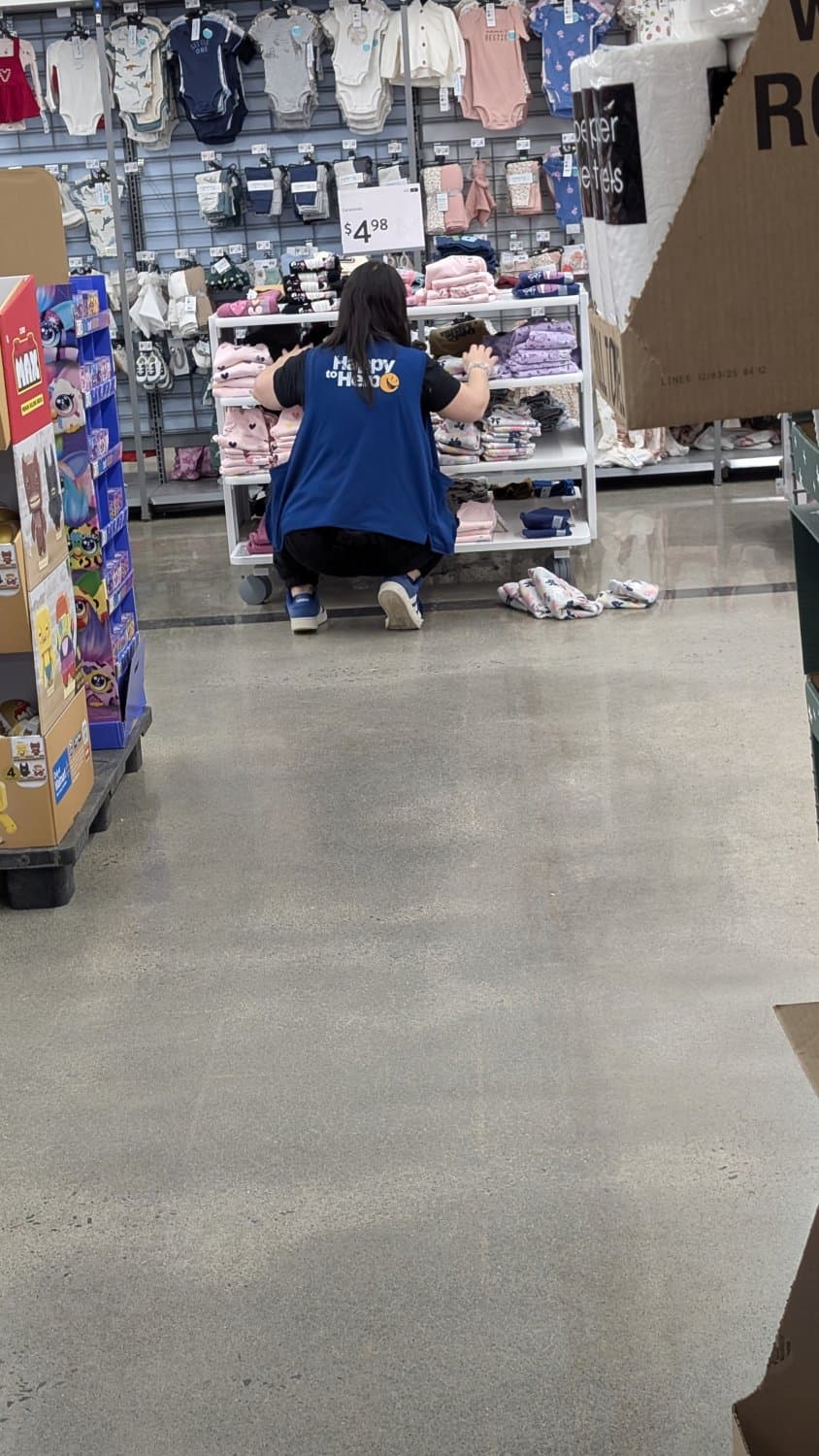 Creepshots of Lindsay doing a split while arranging clothes in apparel. Zoom in for panty shot.