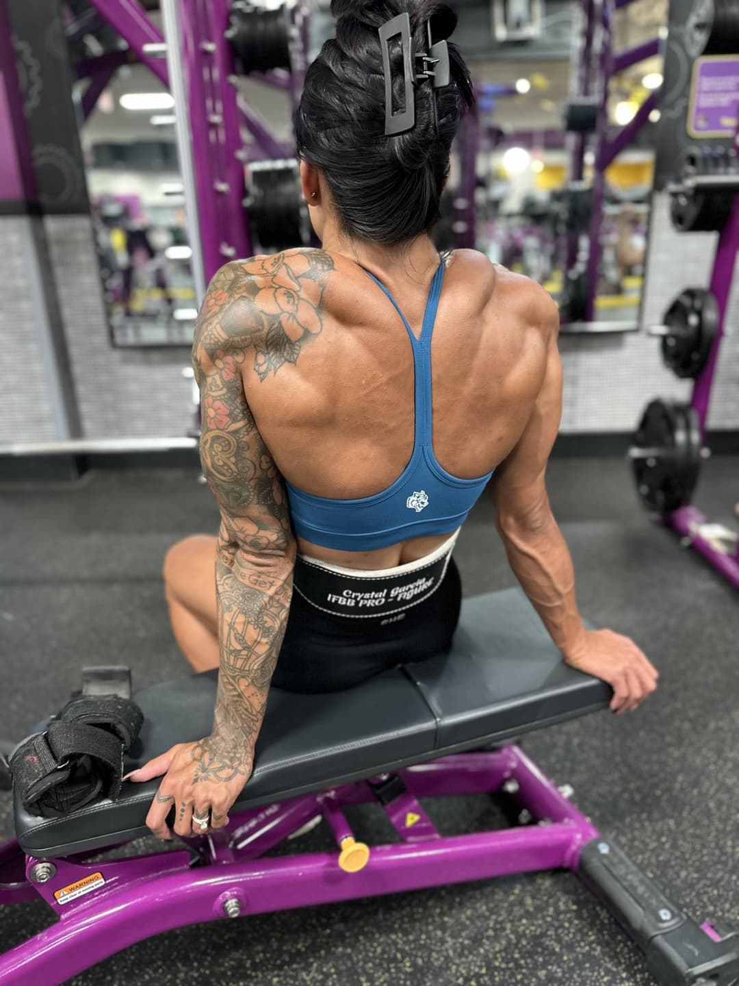 An athletic gym girl has a nice, muscular back